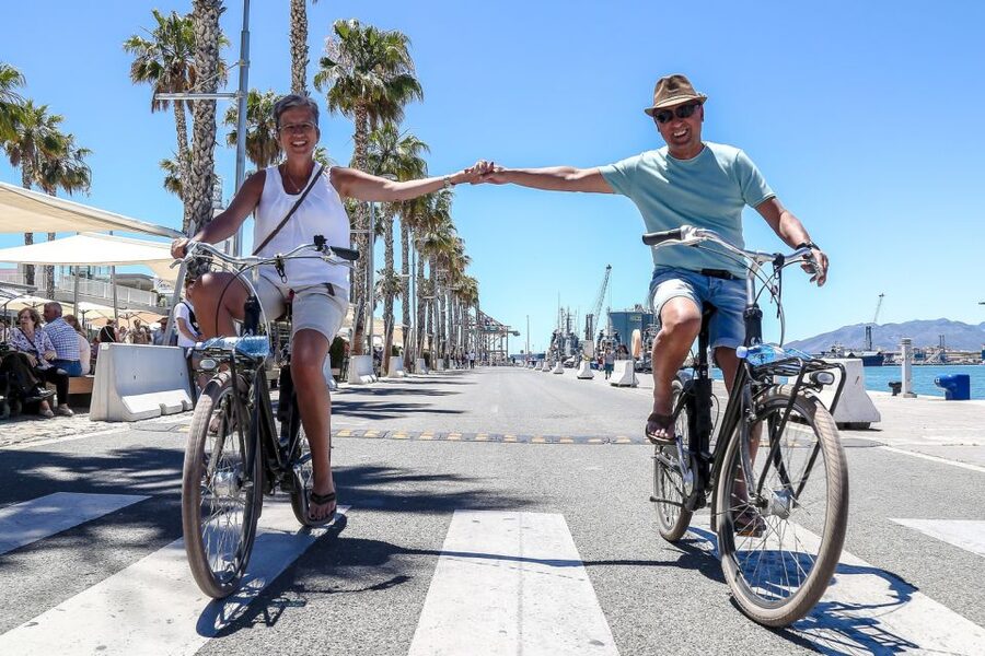 Malaga Bike Tour - Old Town, Marina & Beach - Finding Bike Tours Malaga, Plaza de la Marina, and the Green and Pink Logo