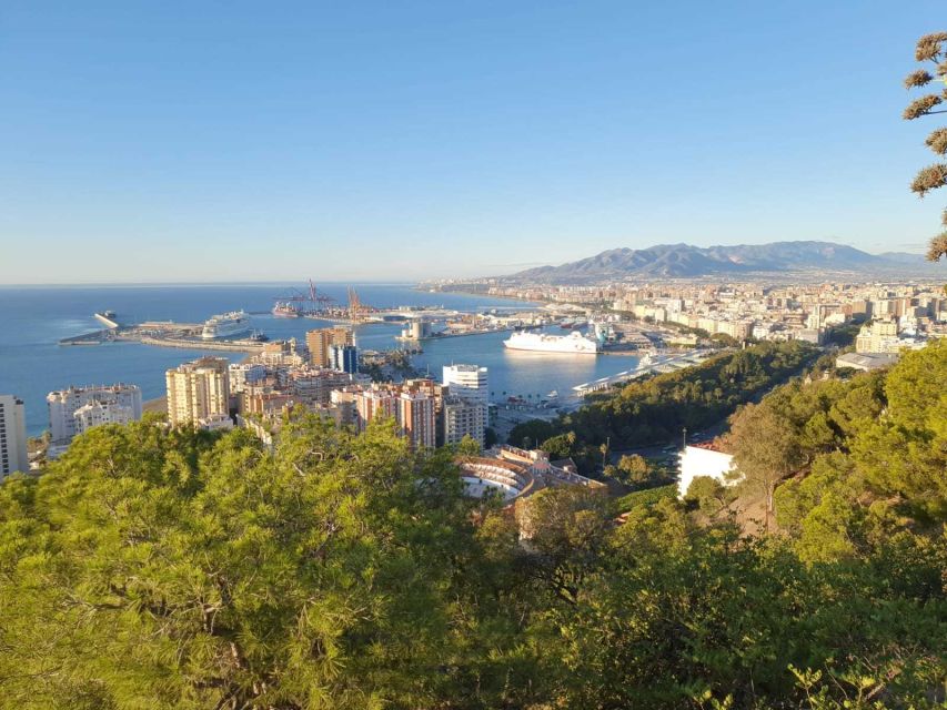 Malaga: Guided E-Bike Tour - Alcazaba area descent, riding past ancient walls