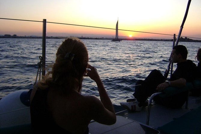 Malaga Sunset Cruise and Restaurant Dinner - The sunset cruise moment: city lights on the water